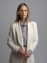 pexels-photo-30468652-30468652 Elegant portrait of a woman in a white blazer with a neutral background, exuding confidence.